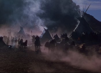 Movie still from “She Wore a Yellow Ribbon” (1949), directed by John Ford – A group of people riding horses through a dusty field; Extreme Wide shot, High angle