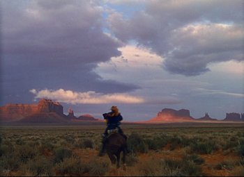 Movie still from “She Wore a Yellow Ribbon” (1949), directed by John Ford – A person on a horse in the middle of the desert; Extreme Wide shot, Low angle