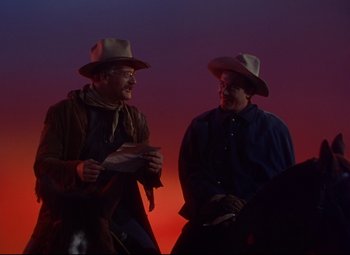 Movie still from “She Wore a Yellow Ribbon” (1949), directed by John Ford – Two men in cowboy hats are talking to each other; Medium shot, Low angle