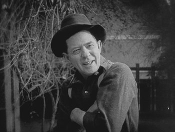 Movie still from “Sherlock Jr.” (1924), directed by Buster Keaton – A man wearing a hat and a jacket; Medium shot, Low angle