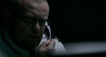 Movie still from “22 July” (2018), directed by Paul Greengrass – A person talking on a cell phone; Close Up shot, Low angle