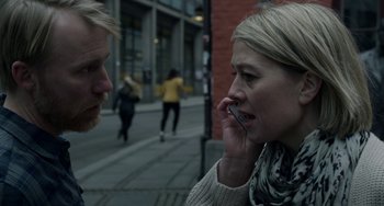Movie still from “22 July” (2018), directed by Paul Greengrass – A man and a woman talking on a cell phone on the street; Close Up shot, Over the shoulder angle