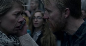 Movie still from “22 July” (2018), directed by Paul Greengrass – A man and a woman looking at each other on a cell phone; Close Up shot, Over the shoulder angle