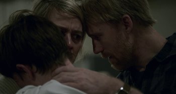 Movie still from “22 July” (2018), directed by Paul Greengrass – A man and a woman hugging each other in front of a wall; Close Up shot, Over the shoulder angle