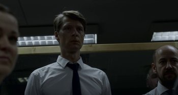 Movie still from “22 July” (2018), directed by Paul Greengrass – A man wearing a white dress shirt and a tie; Close Up shot, Low angle