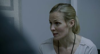 Movie still from “22 July” (2018), directed by Paul Greengrass – A woman with blonde hair wearing a white shirt; Close Up shot, Over the shoulder angle