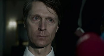 Movie still from “22 July” (2018), directed by Paul Greengrass – A person wearing a white shirt; Close Up shot, Over the shoulder angle