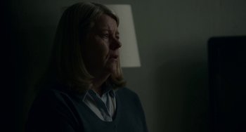 Movie still from “22 July” (2018), directed by Paul Greengrass – A woman in a dark room looking up at the ceiling; Close Up shot, Over the shoulder angle