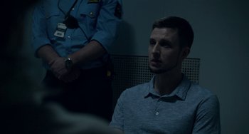 Movie still from “22 July” (2018), directed by Paul Greengrass – A man sitting in front of a police officer; Close Up shot, Over the shoulder angle