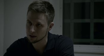 Movie still from “22 July” (2018), directed by Paul Greengrass – A person wearing a black shirt; Close Up shot, Over the shoulder angle