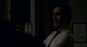 Movie still from “22 July” (2018), directed by Paul Greengrass – A man wearing a white shirt and a black tie; Close Up shot, Over the shoulder angle