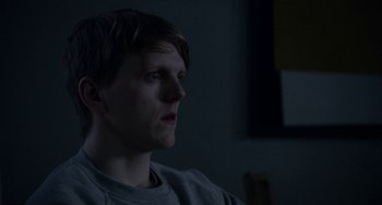 Movie still from “22 July” (2018), directed by Paul Greengrass – A man sitting in a dark room looking up at the ceiling; Close Up shot, Over the shoulder angle