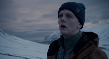 Movie still from “22 July” (2018), directed by Paul Greengrass – A young man in a beanie looking up at the sky; Close Up shot, Low angle