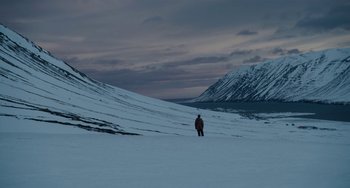 Movie still from “22 July” (2018), directed by Paul Greengrass – A person standing on top of a snow covered slope; Extreme Wide shot, High angle