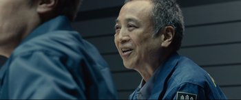 Movie still from “Shin Godzilla” (2016), directed by Shinji Higuchi – An older man is talking to a younger man; Close Up shot, Over the shoulder angle