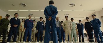 Movie still from “Shin Godzilla” (2016), directed by Shinji Higuchi – A group of people standing in a room; Wide shot, Low angle