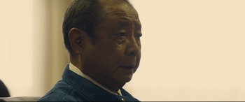 Movie still from “Shin Godzilla” (2016), directed by Shinji Higuchi – An older man is looking into the distance; Close Up shot, Low angle