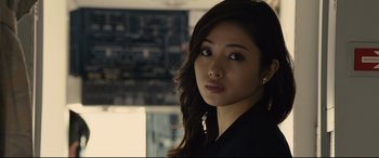 Movie still from “Shin Godzilla” (2016), directed by Shinji Higuchi – A beautiful young woman with long dark brown hair; Close Up shot, Over the shoulder angle