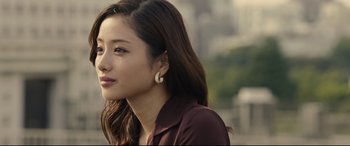 Movie still from “Shin Godzilla” (2016), directed by Shinji Higuchi – A person with long brown hair; Close Up shot, Over the shoulder angle