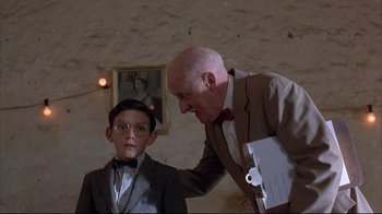 Movie still from “Shine” (1996), directed by Scott Hicks – An older man and a young boy in a room; Medium shot, Low angle