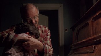 Movie still from “Shine” (1996), directed by Scott Hicks – An older man is hugging a young boy; Medium shot, Low angle