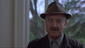 Movie still from “Shine” (1996), directed by Scott Hicks – An older man wearing glasses and a hat; Close Up shot, Over the shoulder angle