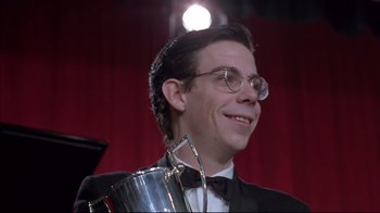 Movie still from “Shine” (1996), directed by Scott Hicks – A man in a tuxedo holding a silver trophy; Close Up shot, Low angle