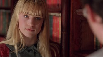 Movie still from “Shine” (1996), directed by Scott Hicks – A woman with blonde hair and a green shirt is posing for a picture; Close Up shot, Low angle