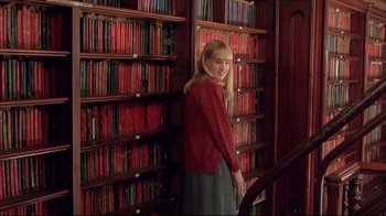 Movie still from “Shine” (1996), directed by Scott Hicks – A woman standing in front of a book shelf; Wide shot, Over the shoulder angle