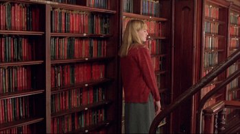 Movie still from “Shine” (1996), directed by Scott Hicks – A woman standing in front of a book shelf; Medium shot, Low angle