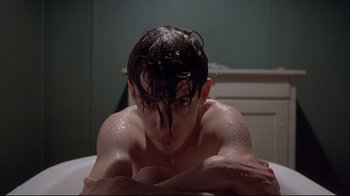 Movie still from “Shine” (1996), directed by Scott Hicks – A man with wet hair is sitting in a tub; Close Up shot, High angle