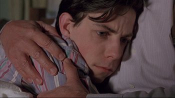 Movie still from “Shine” (1996), directed by Scott Hicks – A person holding a neck tie; Close Up shot, High angle