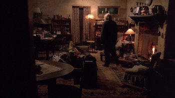 Movie still from “Shine” (1996), directed by Scott Hicks – An older woman standing in a living room next to a couch; Wide shot, High angle