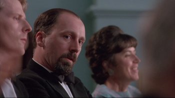 Movie still from “Shine” (1996), directed by Scott Hicks – A man and a woman sitting next to each other in a room; Close Up shot, Low angle