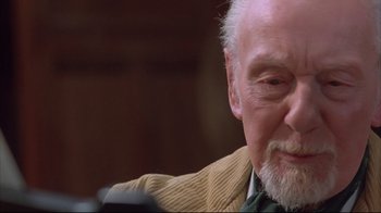 Movie still from “Shine” (1996), directed by Scott Hicks – An older man sitting down with a beard; Close Up shot, Low angle