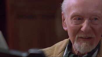 Movie still from “Shine” (1996), directed by Scott Hicks – An older man with a beard and a mustache; Close Up shot, Over the shoulder angle