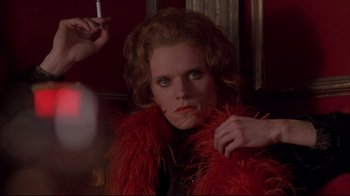 Movie still from “Shine” (1996), directed by Scott Hicks – A woman in a red feather boa is smoking a cigarette; Close Up shot, Low angle