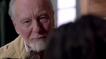 Movie still from “Shine” (1996), directed by Scott Hicks – An old man with a beard and a tie; Close Up shot, Over the shoulder angle