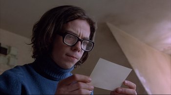 Movie still from “Shine” (1996), directed by Scott Hicks – A woman holding a piece of paper in front of her face; Close Up shot, Low angle