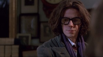 Movie still from “Shine” (1996), directed by Scott Hicks – A man with long brown hair wearing glasses and a jacket; Close Up shot, Low angle