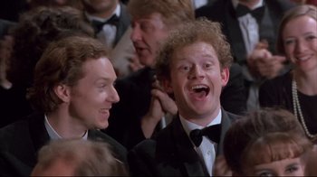 Movie still from “Shine” (1996), directed by Scott Hicks – A group of men in tuxedos and bow ties laughing; Medium shot, High angle