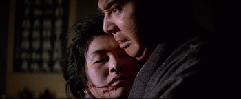 Movie still from “Shogun Assassin” (1980), directed by Kenji Misumi – A man and a woman with blood all over their faces; Close Up shot, Low angle