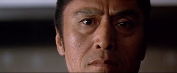 Movie still from “Shogun Assassin” (1980), directed by Kenji Misumi – A person's face looking at the camera; Extreme Close Up shot, Low angle