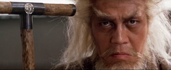 Movie still from “Shogun Assassin” (1980), directed by Kenji Misumi – A person with a long beard; Close Up shot, High angle