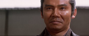 Movie still from “Shogun Assassin” (1980), directed by Kenji Misumi – A man's eyes and face; Close Up shot, Low angle