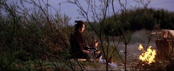 Movie still from “Shogun Assassin” (1980), directed by Kenji Misumi – A woman and a child sitting on the ground; Wide shot, High angle