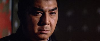 Movie still from “Shogun Assassin” (1980), directed by Kenji Misumi – A man's eyes and face; Close Up shot, Low angle