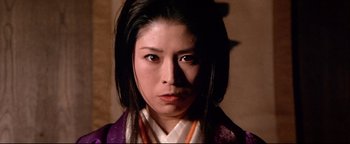 Movie still from “Shogun Assassin” (1980), directed by Kenji Misumi – A person with long black hair; Close Up shot, Low angle