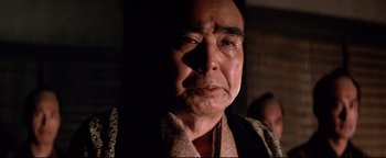 Movie still from “Shogun Assassin” (1980), directed by Kenji Misumi – An older man is looking at the camera; Close Up shot, Low angle