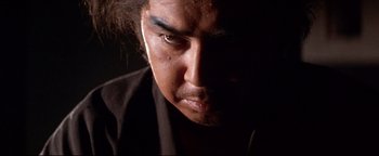 Movie still from “Shogun Assassin” (1980), directed by Kenji Misumi – A man's face in the dark; Close Up shot, Low angle